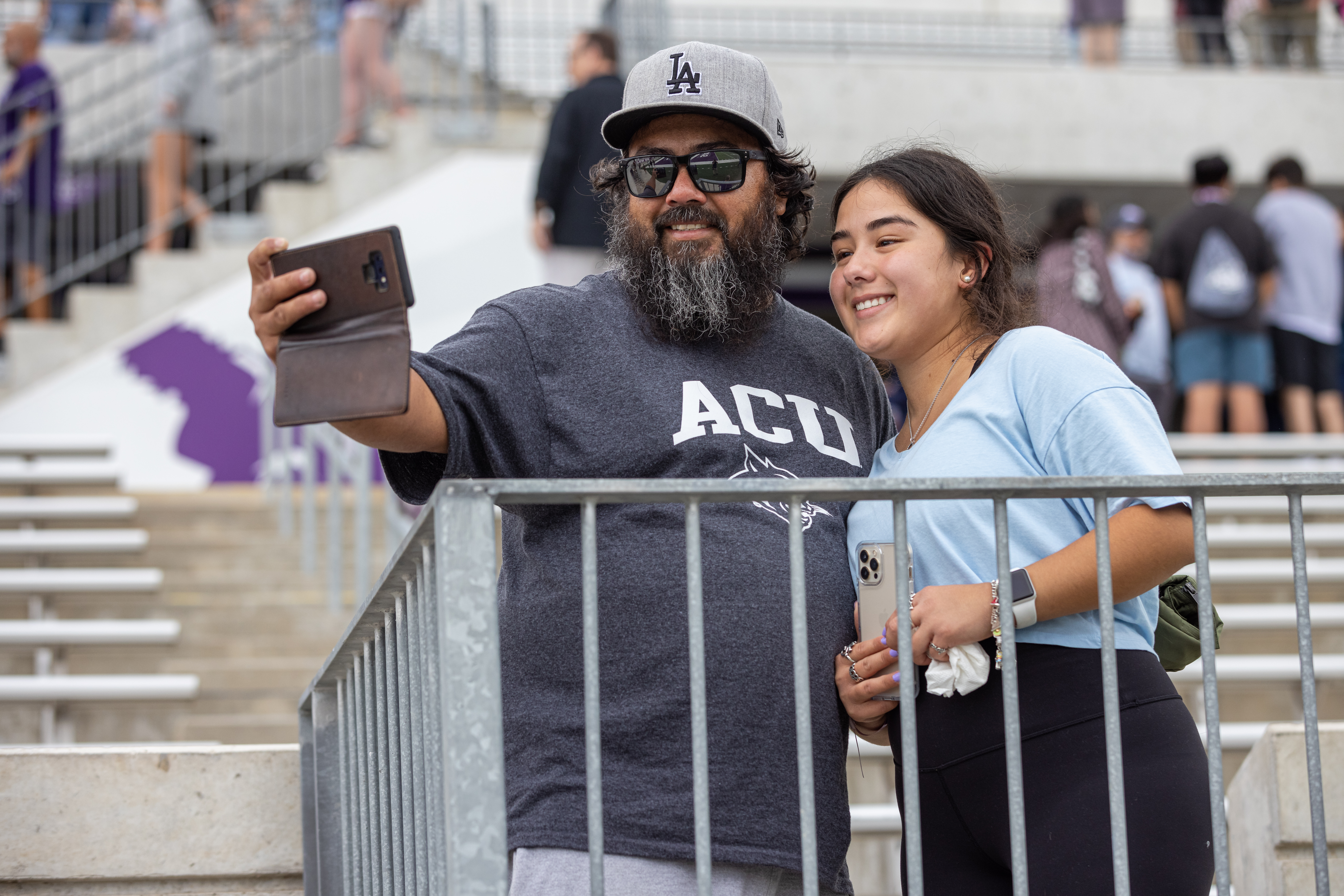 man taking photo with his daughter